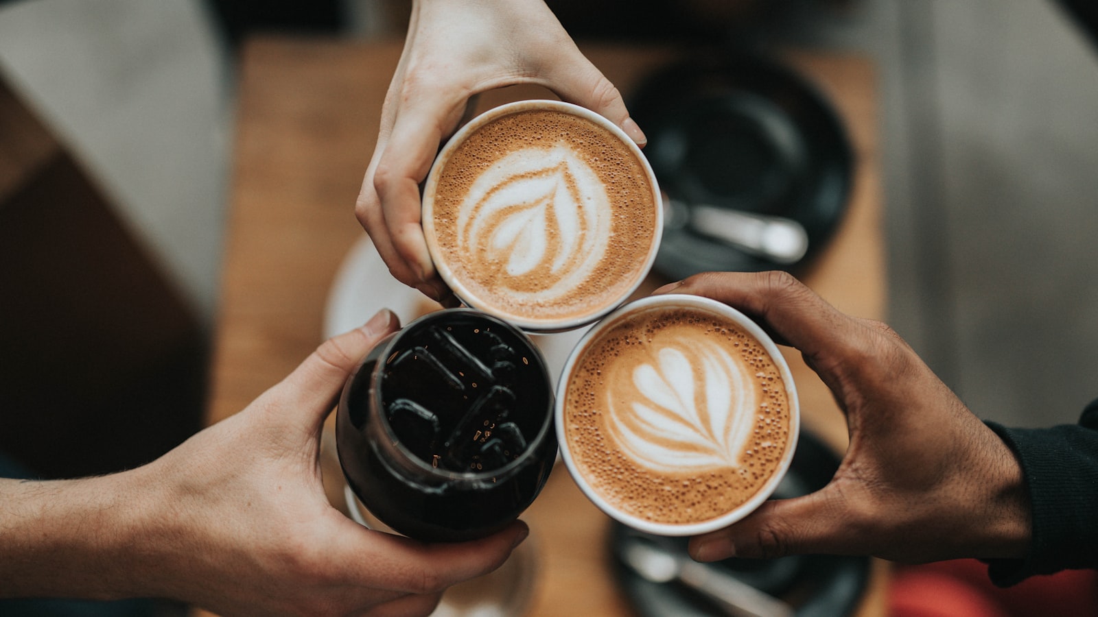 A mug of coffee beside a window in soft morning light