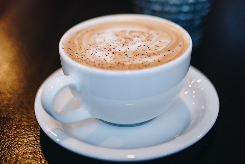 A glass French press filled with dark brewed coffee on a counter