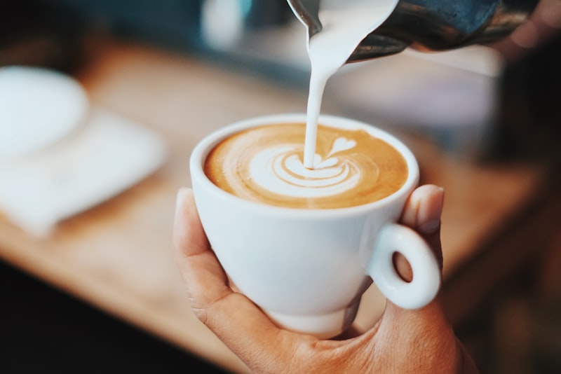 A latte with a poured rosetta pattern in the foam